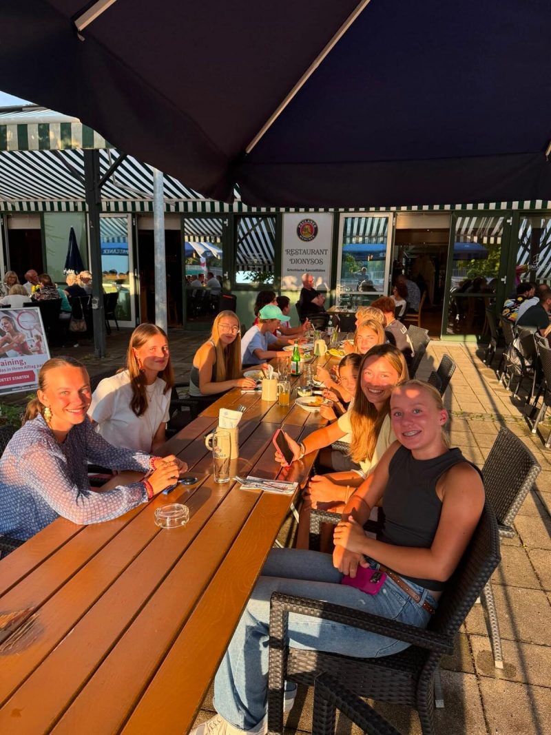 Junge Mitglieder am Tisch im Abendlicht